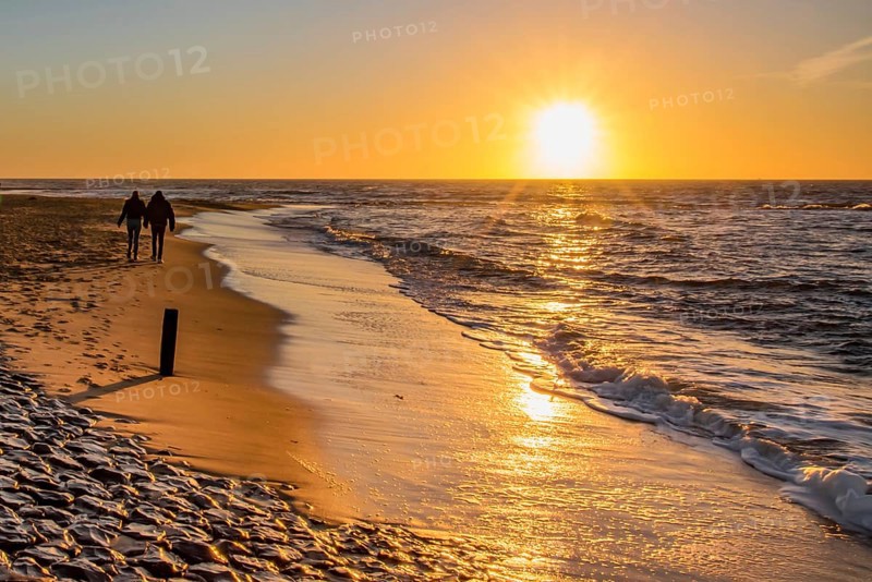 Den Helder, Netherlands. January 2022. Setting sun on the beach of Den Helder, Netherlands.