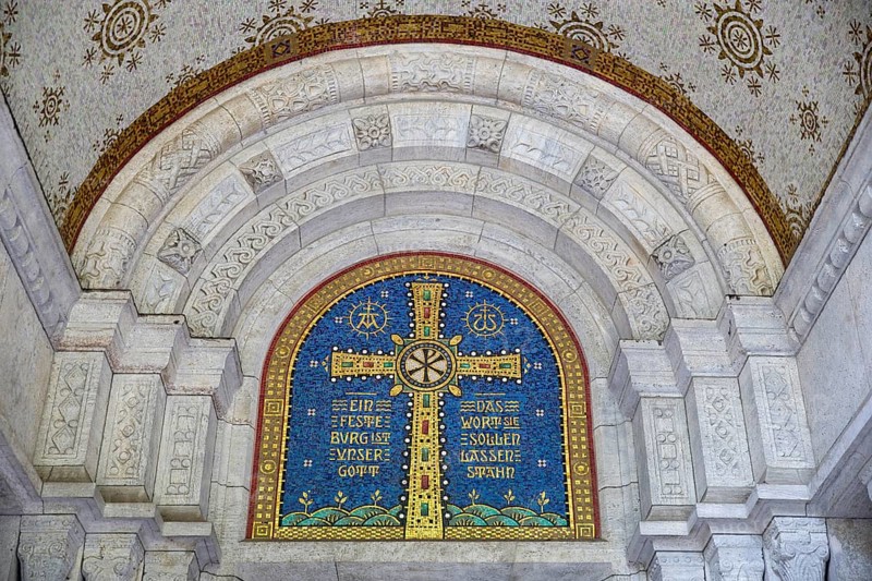 Cross mosaic in the tympanum with the quotation Eine feste Burg ist unser Glauben by Martin Luther, Lutherkirche, Wiesbaden, Hesse, Germany, Europe