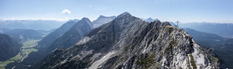 Aerial view, Alpine panorama, hikers at the summit cross, Westliche Wettersteinspitze, Wetterstein Mountains, Bavaria, Germany, Europe