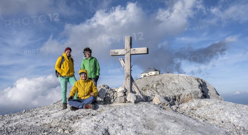 Three hikers at the summit, Hochkönig, Salzburger Land, Austria, Europe
