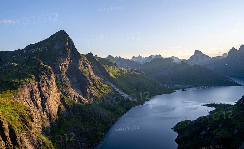 Mountain landscape with pointed mountain peaks and fjord Forsfjorden with village Vindstad, at sunrise, Moskenesoya, Lofoten, Nordland, Norway, Europe