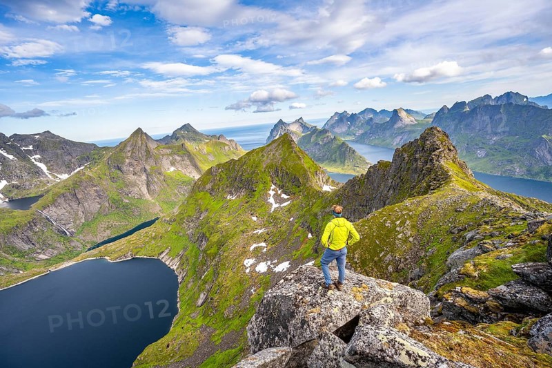 Mountaineers at the summit of Munken, mountain landscape with steep rocky mountain peaks, lake Tennesvatnet fjords and sea, view from the summit of Munken to Reinefjorden, Moskenesoya, Lofoten, Nordland, Norway, Europe