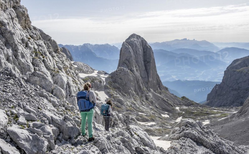 High alpine landscape, snowfields and rock, Two hikers descending from the Hochkönig, Tyrol, Austria, Europe
