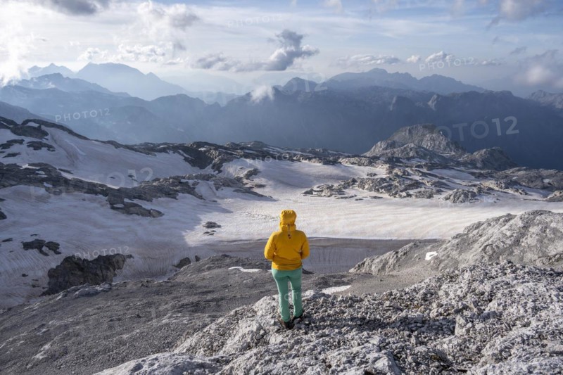 High alpine landscape, snowfields and rock, hiker Looking down into the valley from the Hochkönig, Salzburger Land, Austria, Europe