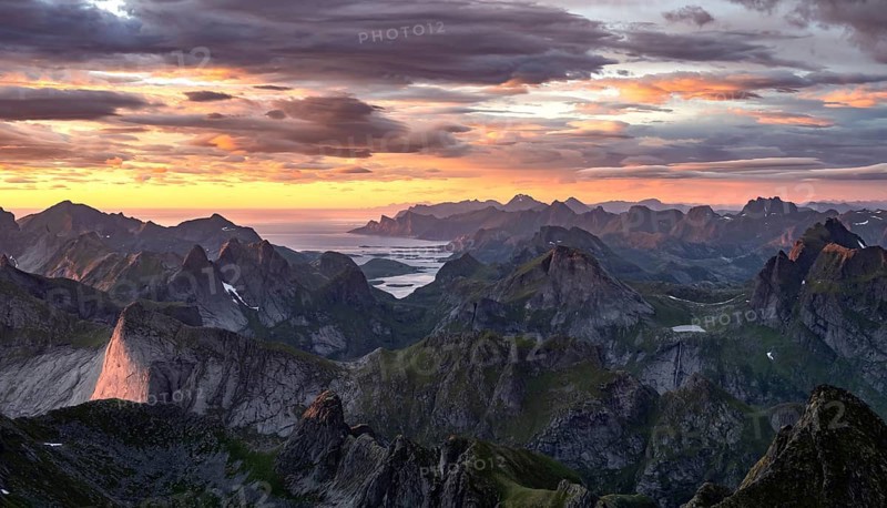 View over mountain top and sea, dramatic sunset, from the top of Hermannsdalstinden, Moskenesöy, Lofoten, Nordland, Norway, Europe