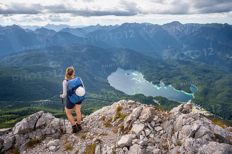 Hiker in the mountains, view of Eibsee lake and Werdenfelser Land, Wetterstein Mountains, Garmisch-Patenkirchen, Bavaria, Germany, Europe