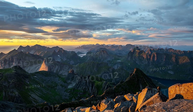 View over mountain top and sea, dramatic sunset, at the top of Hermannsdalstinden, Moskenesöy, Lofoten, Nordland, Norway, Europe