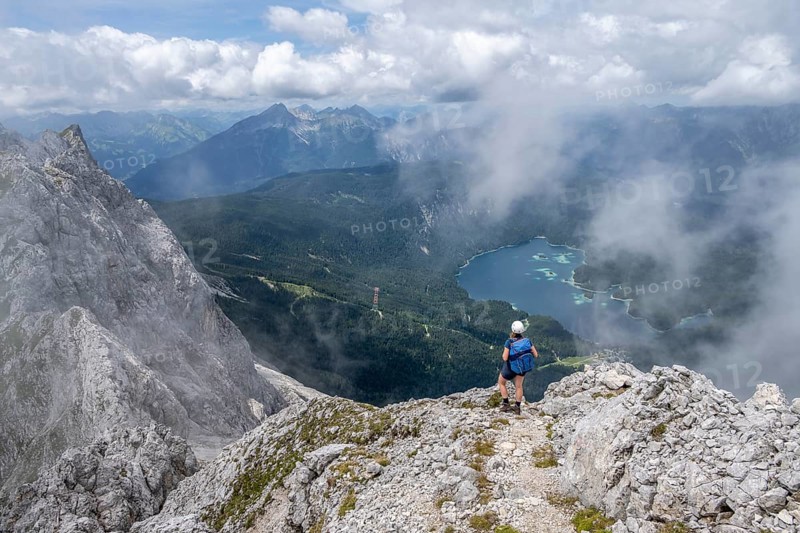 Mountaineer at Waxenstein with fog, Eibsee lake, Wetterstein Mountains, Garmisch-Patenkirchen, Bavaria, Germany, Europe
