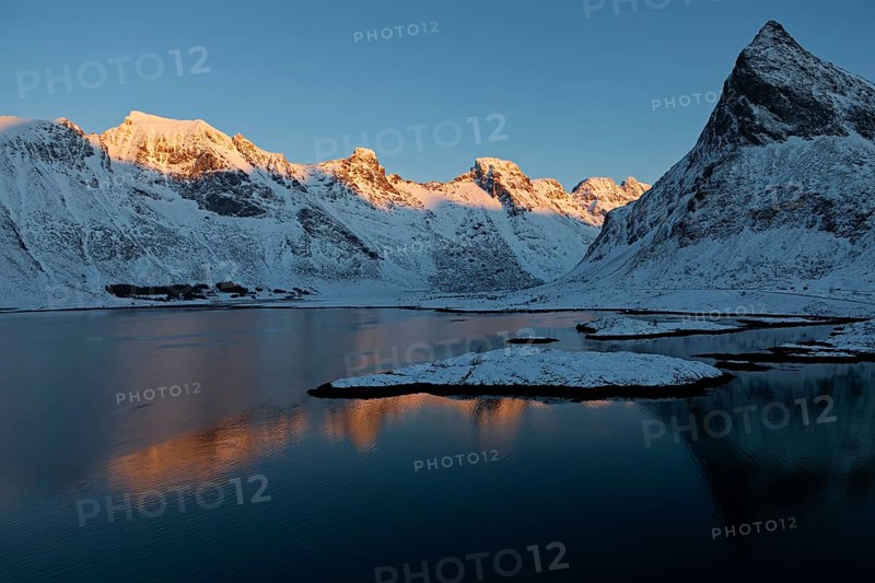 Illuminated mountain range on the Lofoten Islands near Ramberg, Norway, Europe