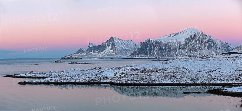 Ramberg with the mountains Hustinden and Bjorntinden in the background in winter dusk