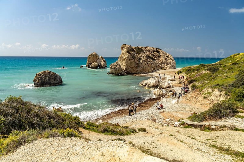 Travelling group at Petra tou Romiou, the Rock of Aphrodite on the coast in Kouklia near Paphos, Cyprus, Europe