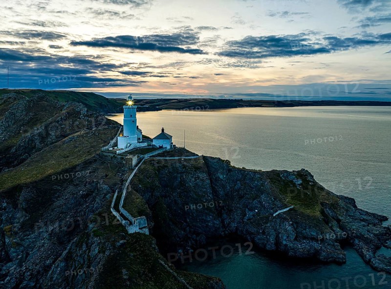 Sunset over Start Point Lighthouse from a drone, Trinity House and South West Coast Path, Devon, England, United Kingdom, Europe