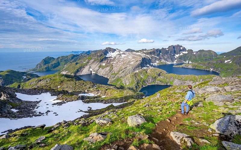 Mountaineers climbing Munken, mountain landscape with steep rocky peaks and lake Tennesvatnet, Krokvatnet and Fjerddalsvatnet, Moskenesoya, Lofoten, Nordland, Norway, Europe