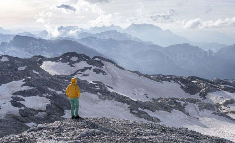 High alpine landscape, snowfields and rock, hiker Looking down into the valley from the Hochkönig, Salzburger Land, Austria, Europe