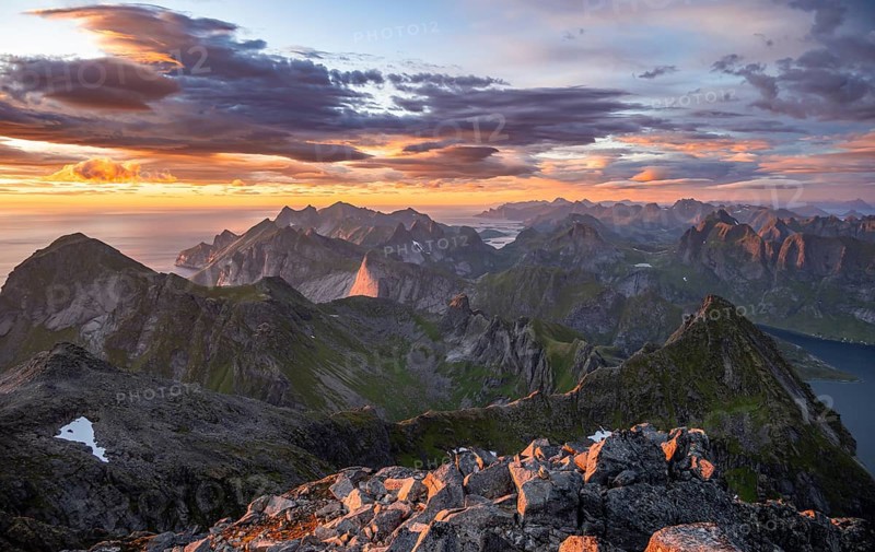 View over mountain top and sea, dramatic sunset, from the top of Hermannsdalstinden, Moskenesöy, Lofoten, Nordland, Norway, Europe