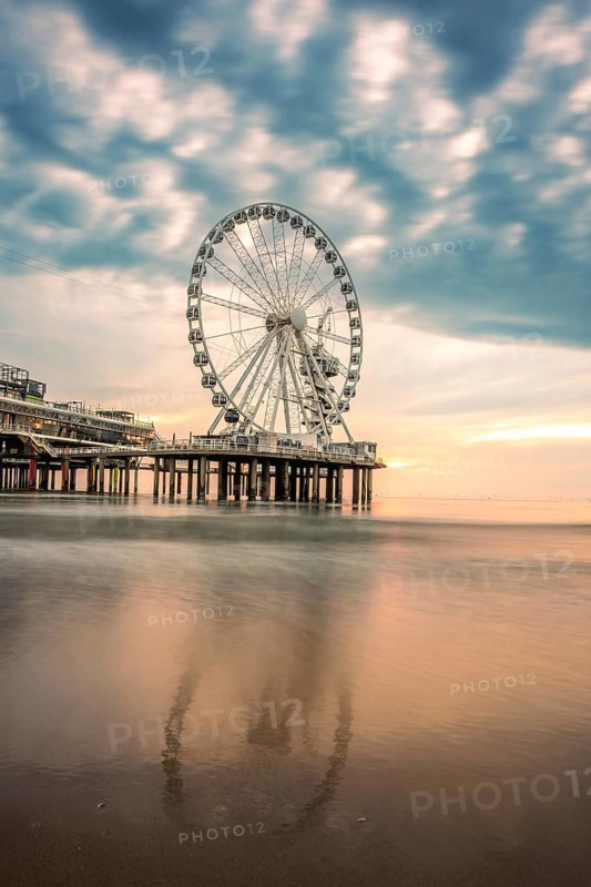 Ferris wheel at sunset on the pier at the beach, The Hague, Netherlands