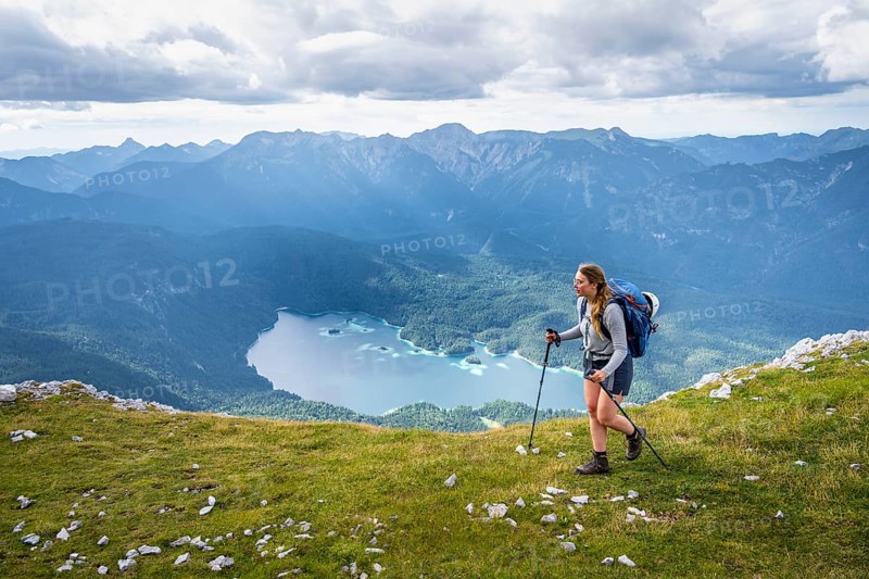 Hiker in the mountains, view of Eibsee lake and Werdenfelser Land, Wetterstein Mountains, Garmisch-Patenkirchen, Bavaria, Germany, Europe