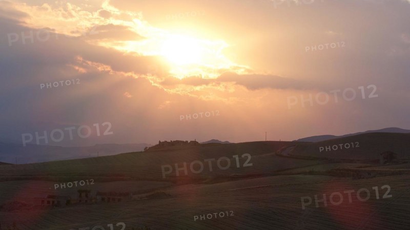 Evening backlight, bare hilly landscape, cloudy sky, single trees, Madonie National Park, autumn, late summer, Sicily, Italy, Europe