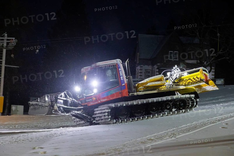 In anticipation of easing of the corona-induced logdown, the ski slope in Altenberg, Saxony, in the Ore Mountains, is artificially snowed with snow cannons. A snow groomer in action