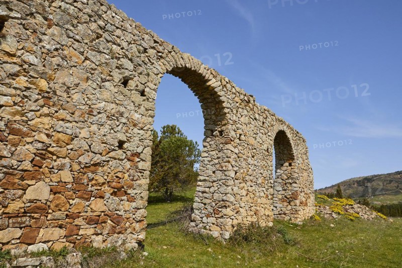 Roman aqueduct, stone arch, green meadow, blue sky, Madonie National Park, spring, Sicily, Italy, Europe