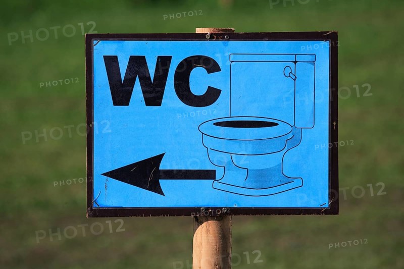 Sign indicating a toilet at a public event