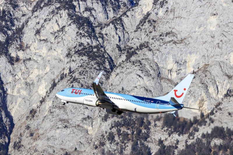 TUI airline aircraft taking off at Innsbruck Kranebitten Airport, Boeing 737-800. Snow-covered mountains of the Alps, Innsbruck, Tyrol, Austria, Europe