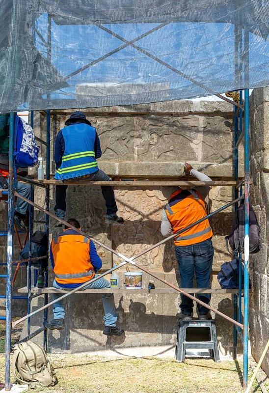 Workers maintaining stonework Eagles and Jaguars platform, Chichen Itza, Mayan ruins, Yucatan, Mexico, Central America