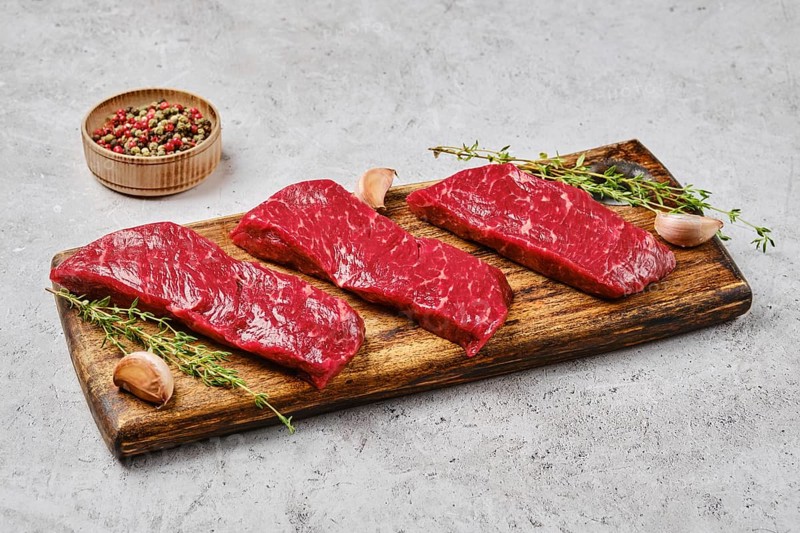 Raw fresh strip steak with spice. Prime beef meat
