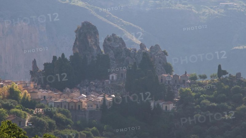 Backlight in the morning, Bizarre rocks, Mountain in the background, Cemetery, Militello Rosmarino, Village, Nebrodi National Park, Sicily, Italy, Europe