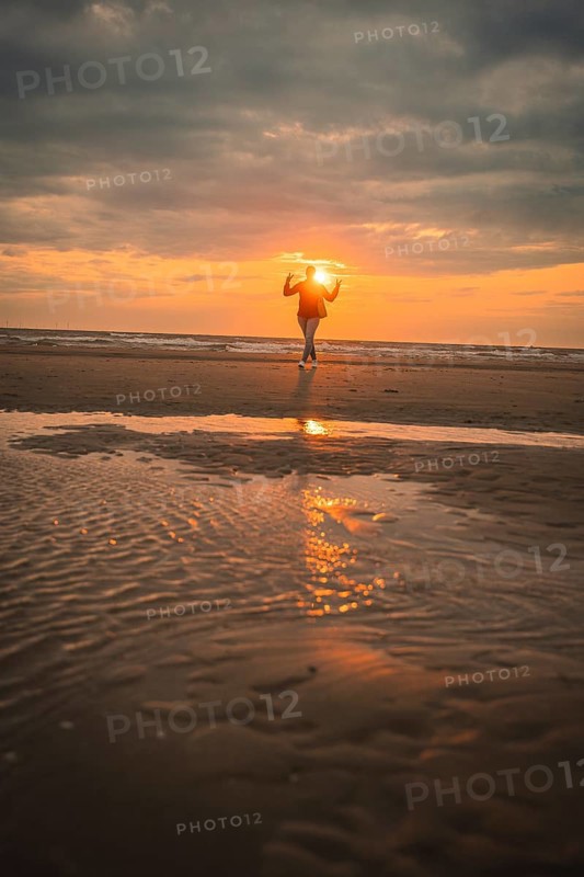 Tourist on the beach at sunset, Zandvoort, Netherlands