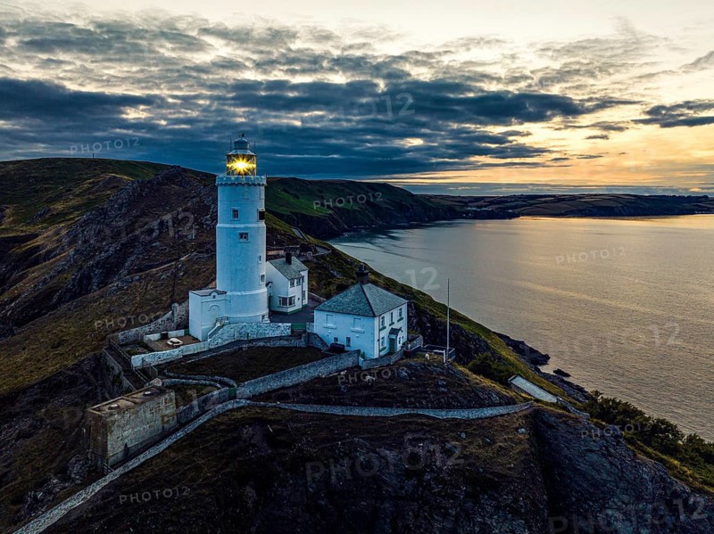 Sunset over Start Point Lighthouse from a drone, Trinity House and South West Coast Path, Devon, England, United Kingdom, Europe
