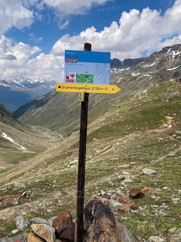 Signpost for hikers trekking hiking trail in Alps alpine high mountains above tree line in Ötztal towards 2738 metres high Brunnenkogelhaus, Tyrol, Austria, Europe