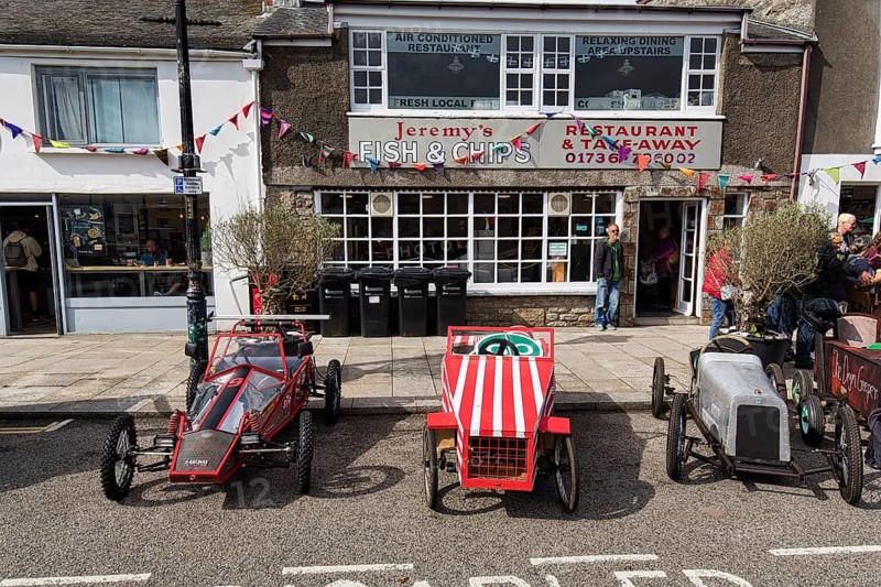 Traditional soapboxes parked by the roadside in the town centre, Lafrowda Festival 2023, St Just in Penwith, Cornwall, England, United Kingdom, Europe
