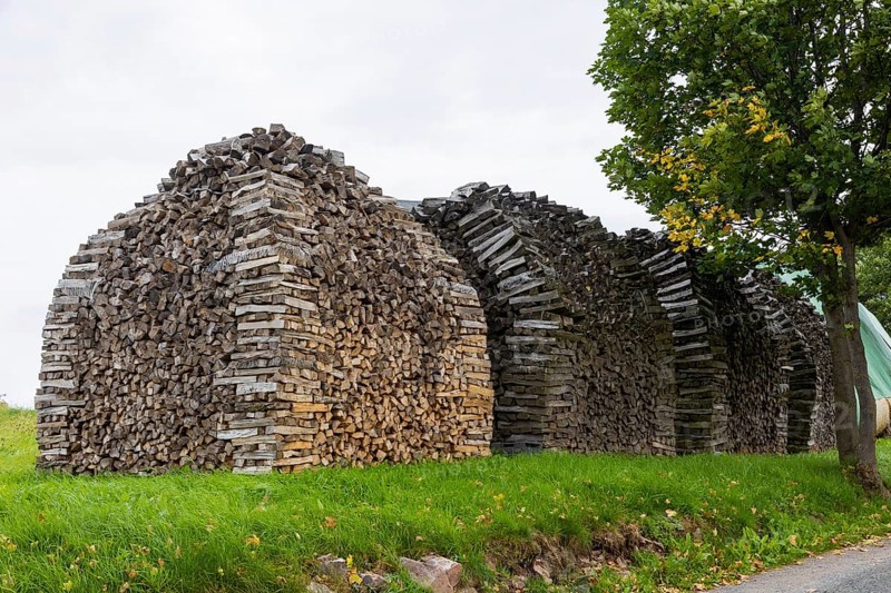 Split wood stacked for rent to dry better. Wood is becoming increasingly popular as a heating material. Here artful stacks in Altenberg in the Ore Mountains