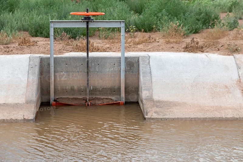 San Acacia, New Mexico, A gate on an irrigation canal allows water from the Rio Grande to be directed to a specific field. Much of the state is experiencing extreme drought, and farmers are not getting all the water they need to grow their crops in the desert