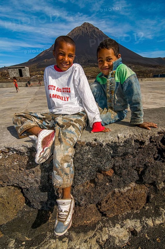 Smiling, happy boys in front of vulcano on Fogo. Cabo Verde. Africa