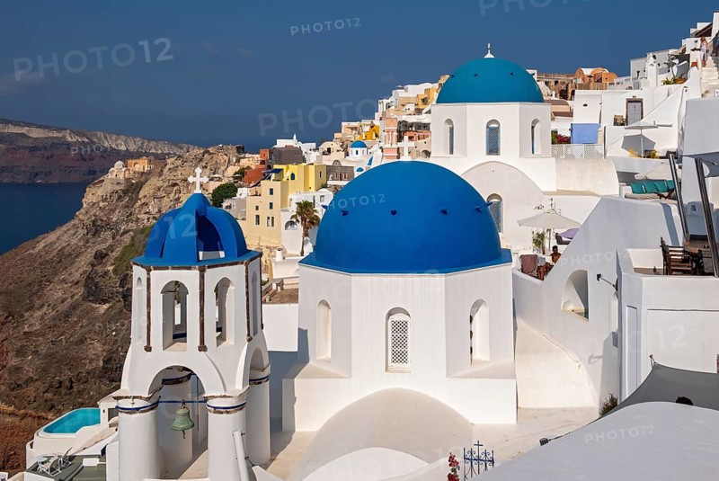 White churches with blue dome, Agios Spiridonas, St Spyridon, and Church of Anastasis, Resurrection, Ia, Oia, Santorini, Greece, Europe