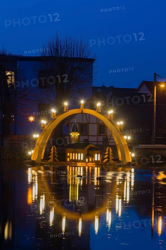 Floating candle arch in the village pond of Bärnsdorf near Moritzburg. The arch is 4.5m high, almost 8m wide and was built by local craftsmen as a special decoration for the local Christmas market
