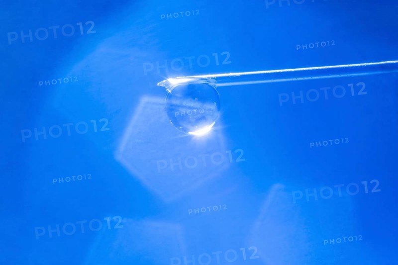 Macro image Covid vaccine, a drop of Moderna vaccine hangs on a vaccine needle