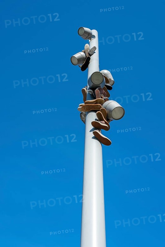 Trainers hanging from a modern light pole, Berlin, Germany, Europe