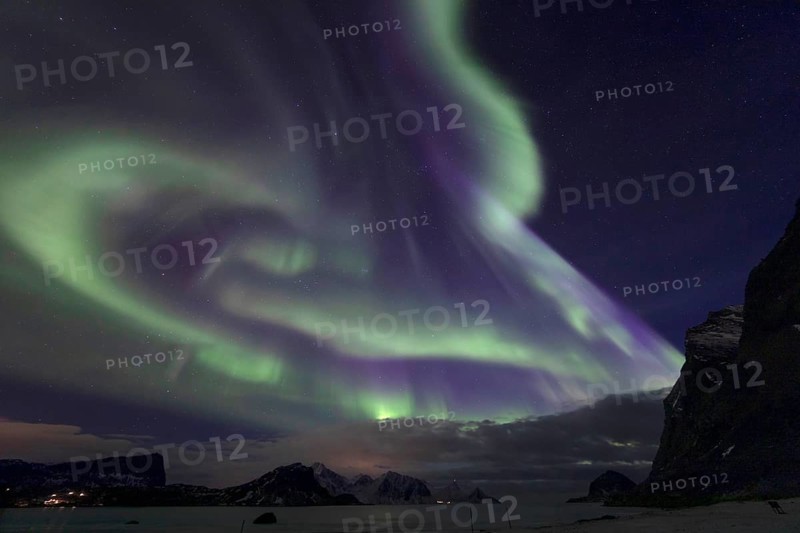 Northern Lights (Aurora borealis) in green and blue over the beach of Haukland, Lofoten, Norway, Europe