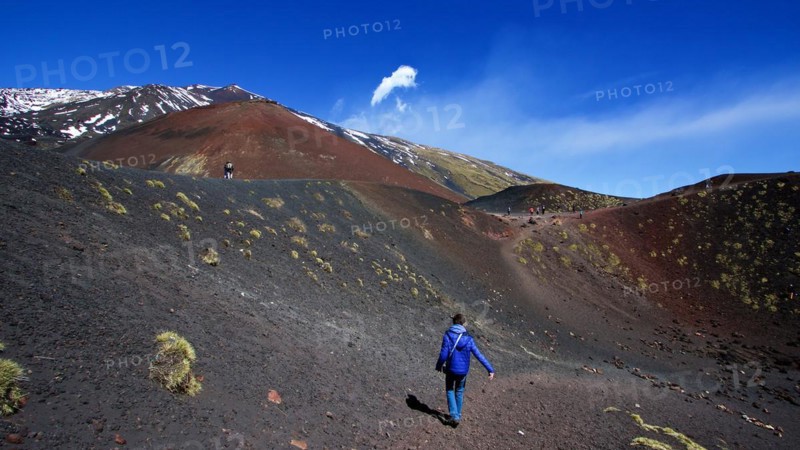 Lone visitor in crater, black lava field, red lava hill, Crateri Silvestri, Etna, volcano, Eastern Sicily, Sicily, Italy, Europe