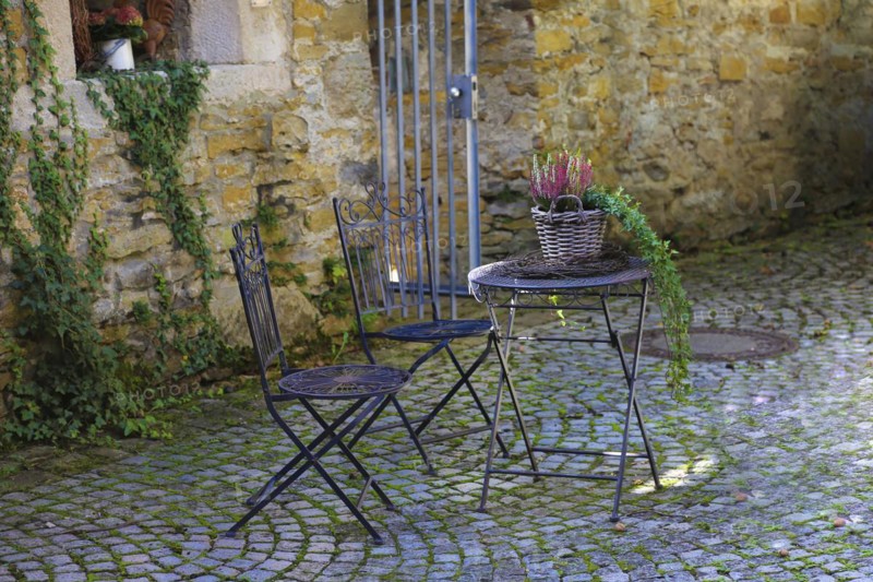 Still life at the castle wall, garden furniture, seating group, chairs, table, plants at the circular wall, Gomaringen Castle, former parsonage of Johann Ulrich Schwindrazheim, Gustav Schwab Museum, former aristocratic residence, historical building, former castle, architecture, Gomaringen, Baden-Württemberg, Germany, Europe