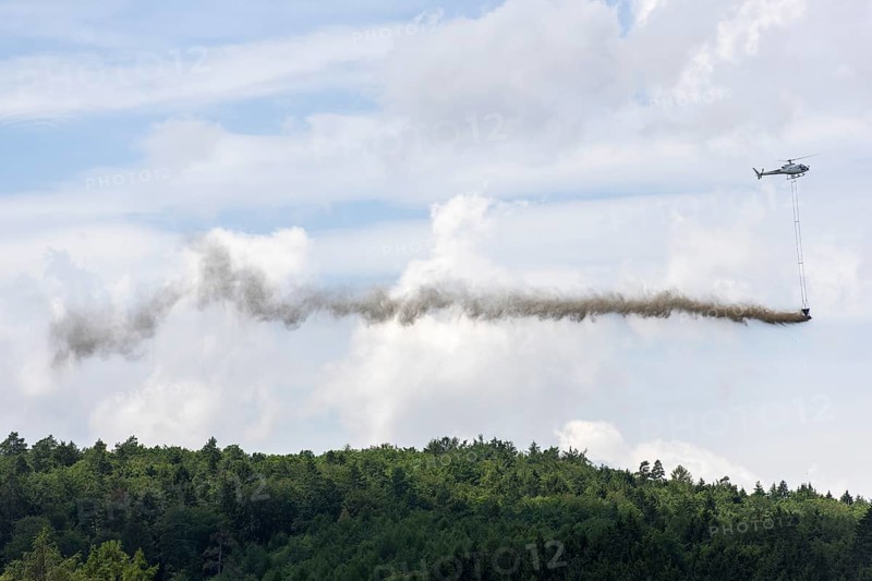 Symbolic image, climate change, helicopter, helicopter spreading finely painted limestone and wood ash against acid rain, mixed forest, container, soil protection liming, forest liming, Baden-Württemberg, Germany, Europe