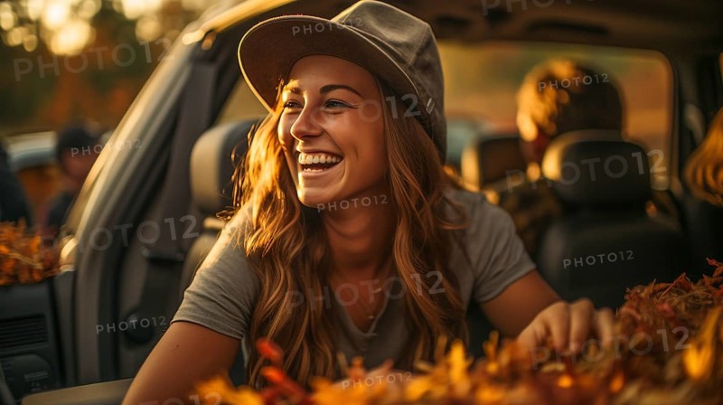 Young adult female farmer wearing cowboy hat sitting on the tailgate of her truck outdoors amongst her pumpkin patch harvest, generative AI