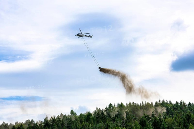 Symbolic image, climate change, helicopter, helicopter spreading finely painted limestone and wood ash against acid rain, mixed forest, container, soil protection liming, forest liming, Baden-Württemberg, Germany, Europe