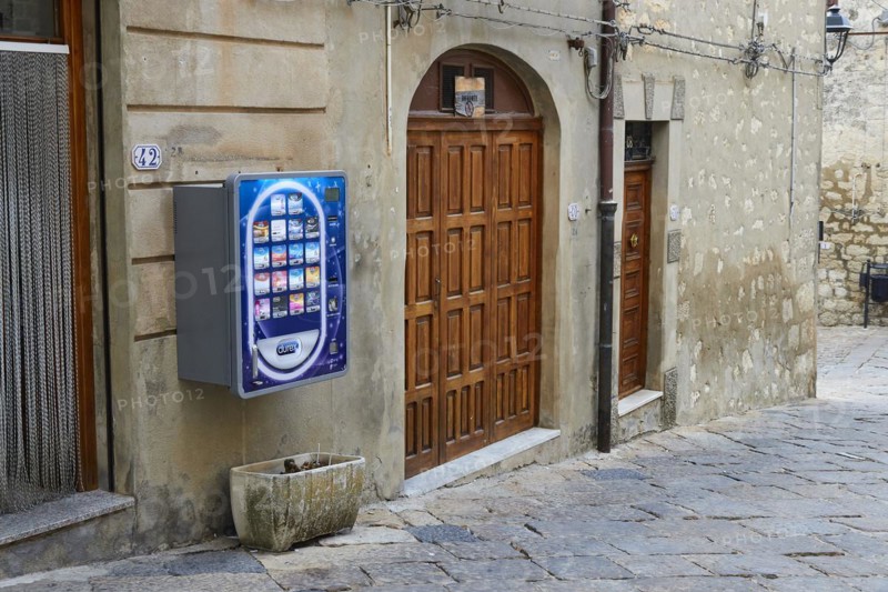 Colourful condom vending machine on historic building, Petralia Soprana, village in the National Park, Madonie National Park, Sicily, Italy, Europe
