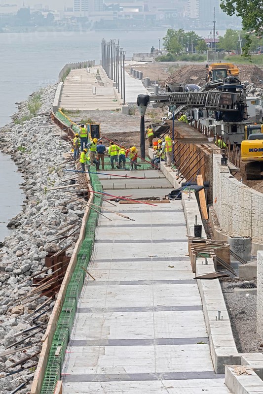 Workers pour cement to complete a section of the Detroit Riverwalk on the site of the former Uniroyal tire factory. The walking-biking path along the Detroit River has been named the Best Riverwalk in America