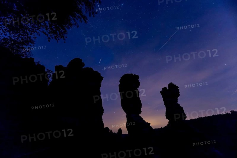 Pereids over Saxon Switzerland. Hercules Pillars in the Bielatal, the striking rock formations stand out impressively against the night sky. The shooting stars race across the night sky at 216, 000 km h and burn up