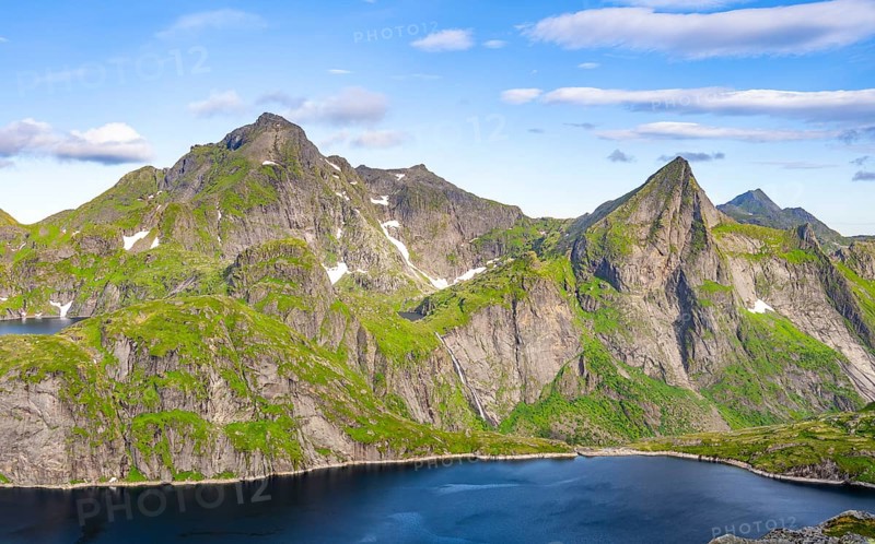 Mountain landscape with lake Tennesvatnet and steep rocky mountain peak with waterfall, peak of Hermannsdalstinden, view from the top of Munken, Moskenesoya, Lofoten, Nordland, Norway, Europe